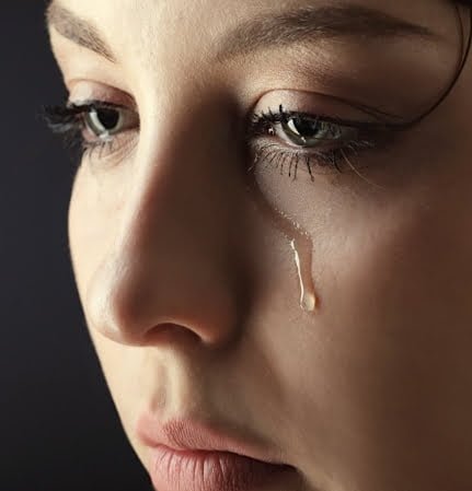 female with tears: trauma due to failed relationships or first-love breakup