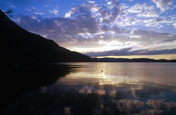 Evening landscape during sunset with a lake and mountain