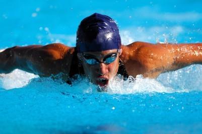 Athlete swimming while training muscles with strong inspirations