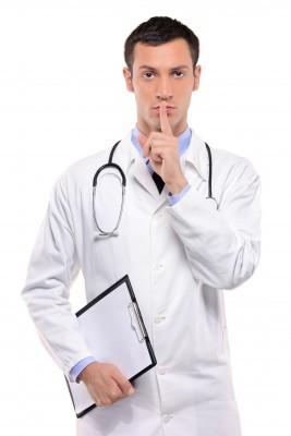 Doctor with a hushing sign