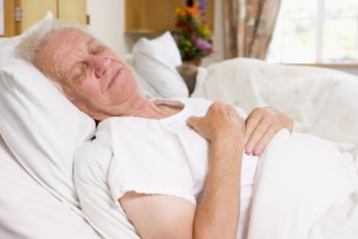 Old man sleeping in hospital bed