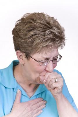 Woman coughing with acute asthma exacerbation symptoms