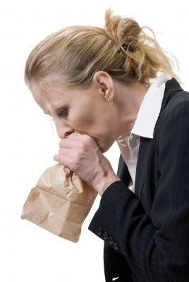 Hyperventilation Treatment - Woman breathing in paper bag for treatment of hyperventilation