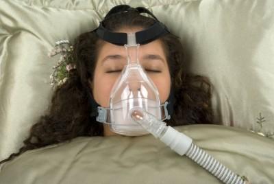 Woman sleep with CPAP machine
